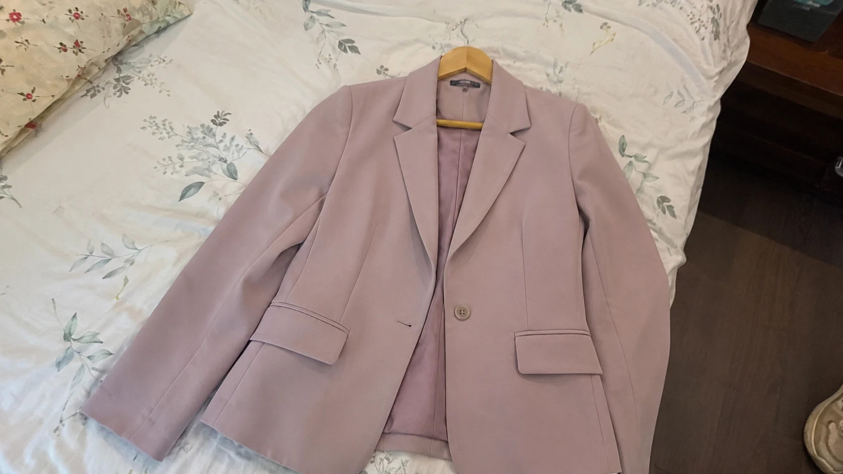 Raw photo of pink tailored blazer on hanger